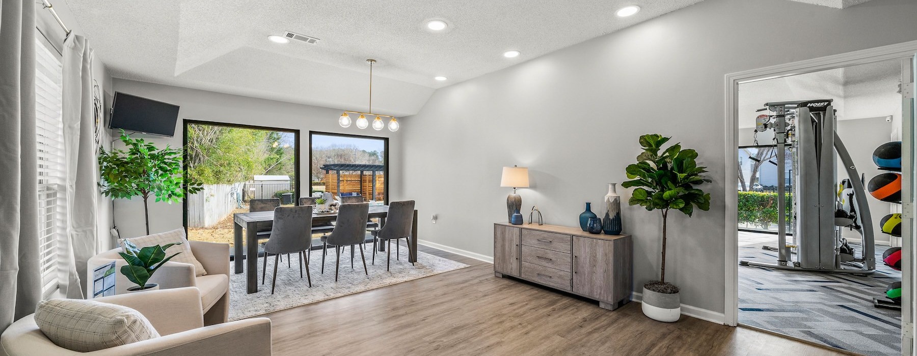 a clubhouse room with a wood floor, chairs and tables