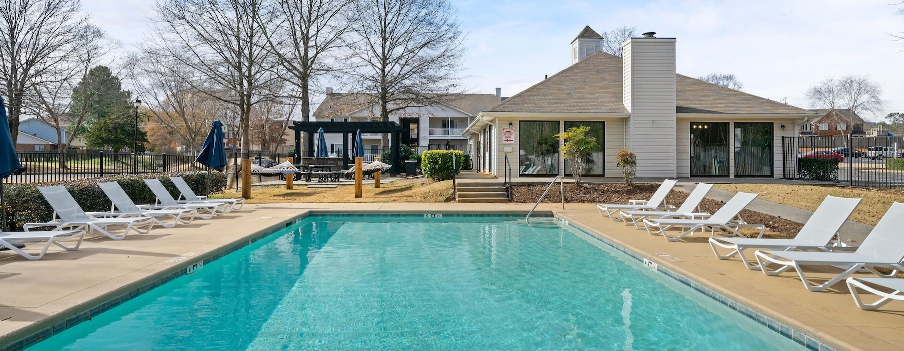 a swimming pool with chairs around it