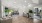 a clubhouse room with a wood floor, chairs and tables
