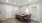 a room with a desk and chairs