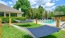 a pool area with grass and hammocks