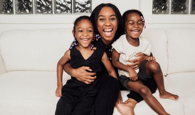 The essence of exceptional living a woman sitting on a couch with two kids